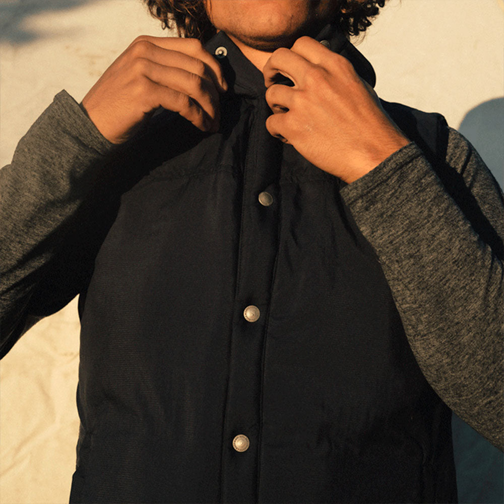 A man wearing a blue American made Duckworth soft shell wool insulated vest.